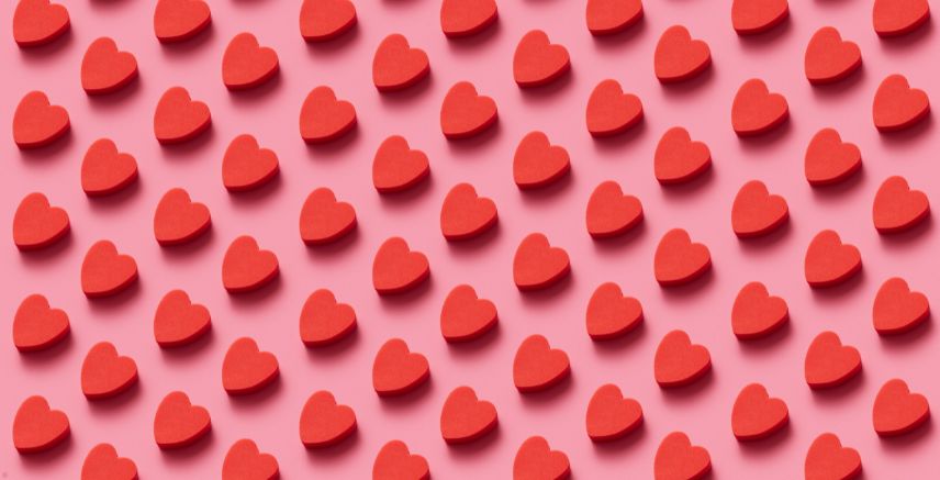 A digital drawing of red hearts on a pink background.