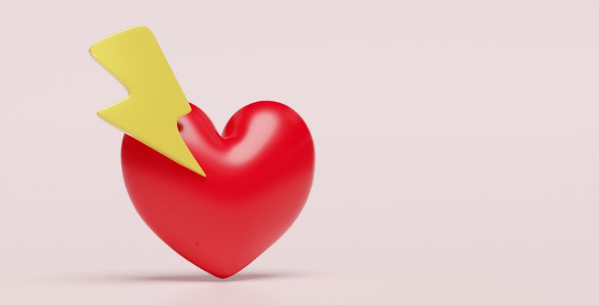 A red heart with a yellow lightening bolt on top of it, against a light pink background.